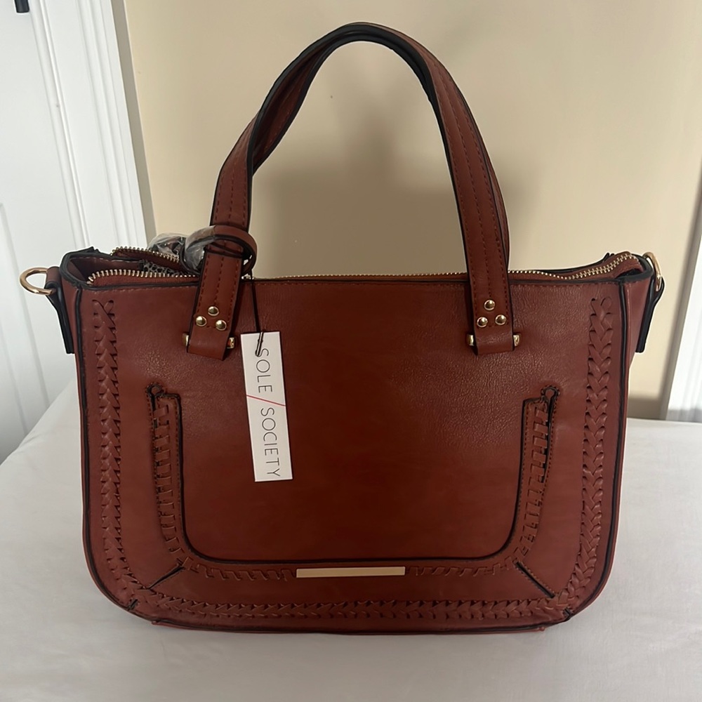 Soul society, new with tags pocketbook. The color is whiskey brown.